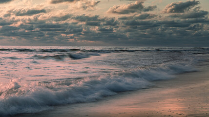 Fototapeta premium Long exposure sunset at Baltic sea beach with soft waves 