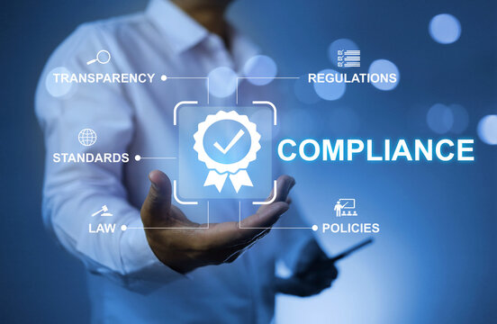 Compliance concept with businessman holding quality sign to applied standard and regulation to meet business requirement