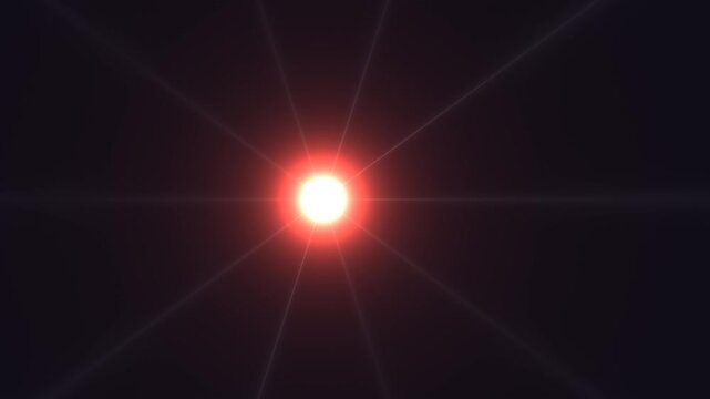 Bright red light shines in dark background creating visual effect