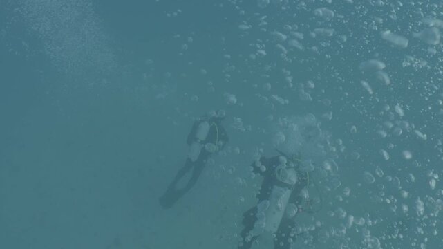 log footage of an airplane wreck underwater scuba divers to explore  metal on ocean floor