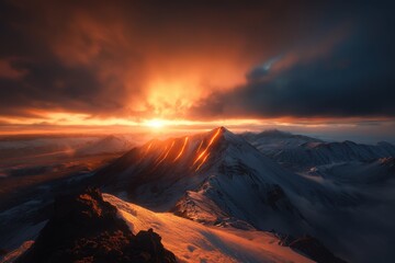 Naklejka premium A fiery sunset lights up a snowy mountain peak, casting dramatic shadows over the rugged landscape beneath a turbulent sky.