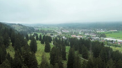 Fototapeta premium Aerial view observing the mountain village at sunrise fog