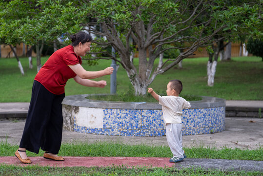 Family bonding between grandmother and toddler outdoors