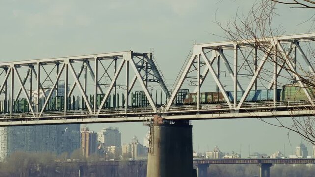 Freight Train Moving On Metal Railway Bridge. Cargo Transportation And Logistics