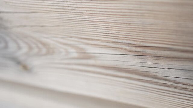 Wooden board with natural texture and grain, sliding with soft focus for a calm background concept. Organic materials, rustic design and natural aesthetics.