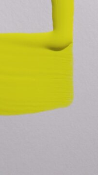 Vertical Yellow paint drip brush stroke on white textured paper background