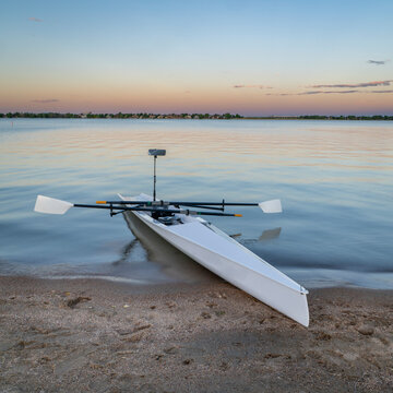 Coastal rowing shell on a shore of Boyd Lake in northern Colorado at dusk