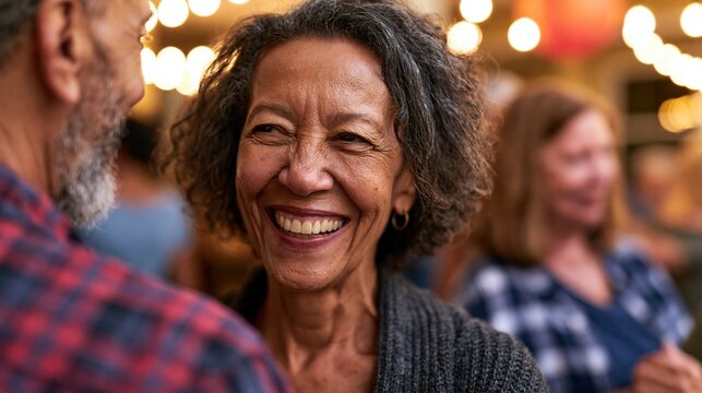 Mature woman laughing during social dance partner rotation at community event
