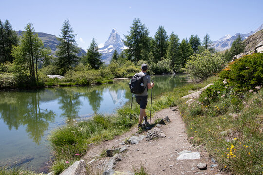 man backpacker on hike 5 Lakes Trail, Zermatt, Matterhorn, Switzerland