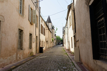 Fototapeta premium Beaune city street with old architecture and cobblestone pavement