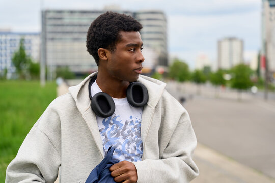 Young Man Walking on Urban Street in City