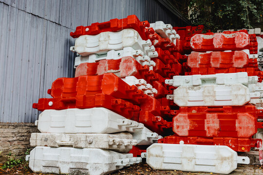 Stacked Red and White Plastic Traffic Barriers at Construction Site