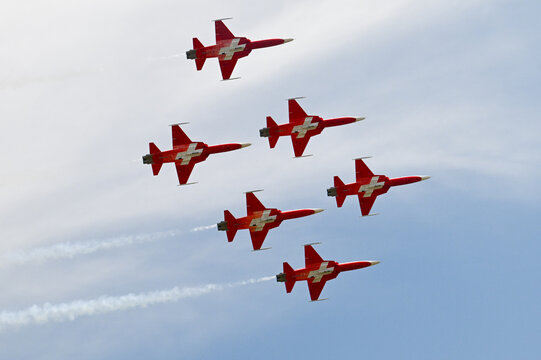 Grenchen, Switzerland - 11.07.2026: Patrouille Suisse aerobatic team flies tight formation with smoke trails during flight show.