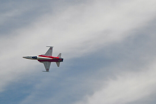 Grenchen, Switzerland - 11.07.2026: Patrouille Suisse Northrop F-5E Tiger II flies aerobatic pass against cloudy sky during airshow.