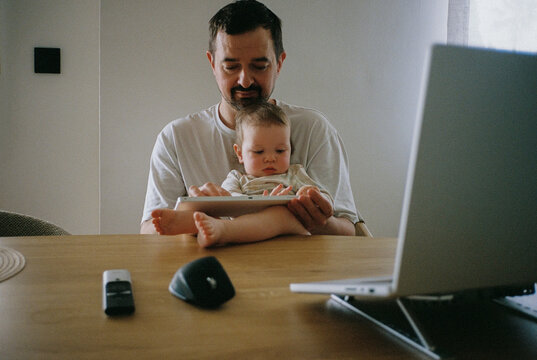 Father and baby typing on a keyboard