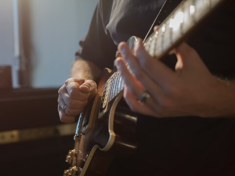 Musician Plays Electric Guitar in Studio During Practice Session