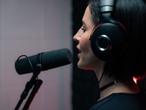 Woman singing in recording studio 