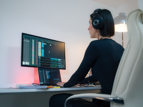 Woman Making Music With Computer in Home Studio Setup