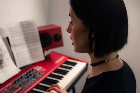 Woman playing piano and singing song 