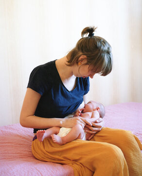 Woman breastfeeds her baby