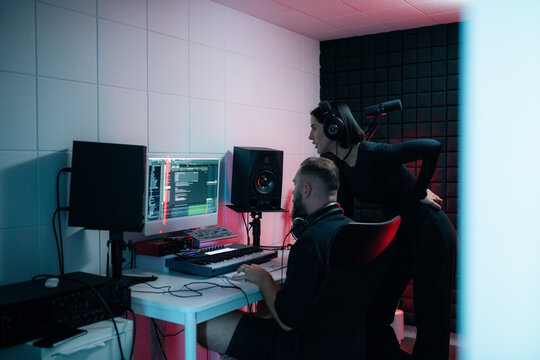 Singer watching mastering process at studio 