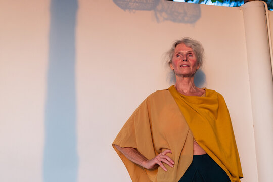 Calm Confident Senior Woman portrait with Copy Space, yellow top