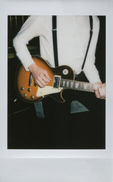Polaroid photo of a musician playing an electric guitar