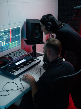 Two Musicians Collaborate in a Music Studio