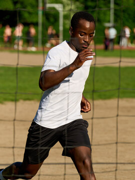 Boy Runs on a Soccer Field During a Game in Bright Daylight