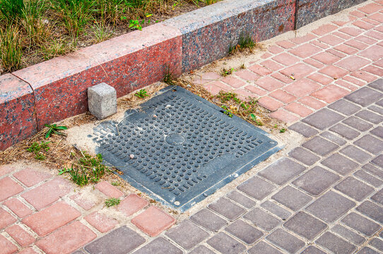 Urban street detail with granite curb and patterned paving stones