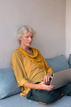 Senior Woman Working on Laptop, Focused Remote Work Portrait, email