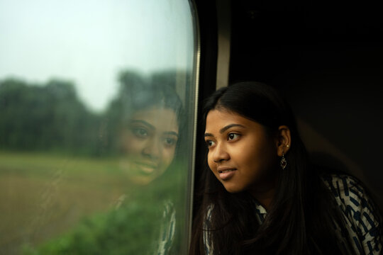 An Young Indian woman traveling by train 