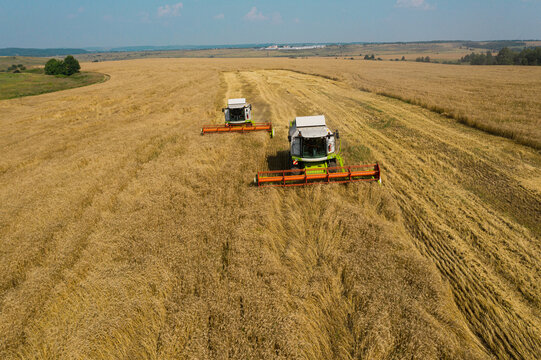Aerial view of combine harvester in wheat field