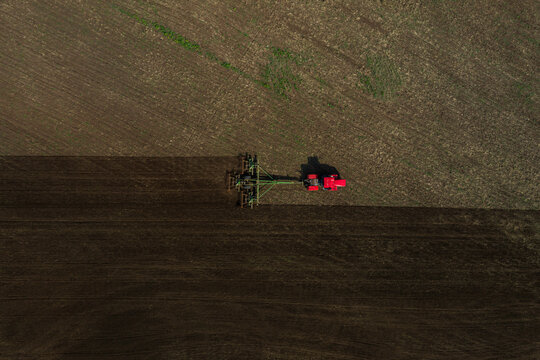 Farm machinery riding in grassy field