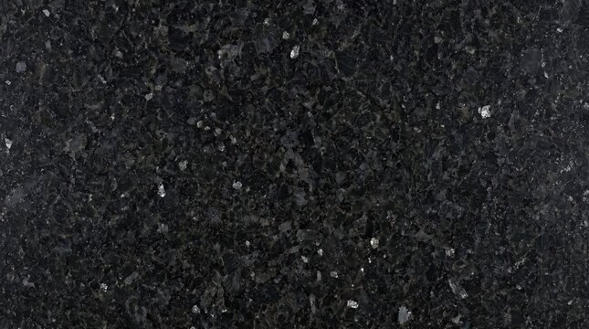 A close-up view of a dark granite surface with flecks of white and gray speckles