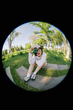 Young Person Takes a Picture in the Park During Daytime Sunshine