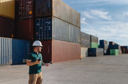 Logistics Supervisor Using Two-Way Radio at Container Shipping Yard