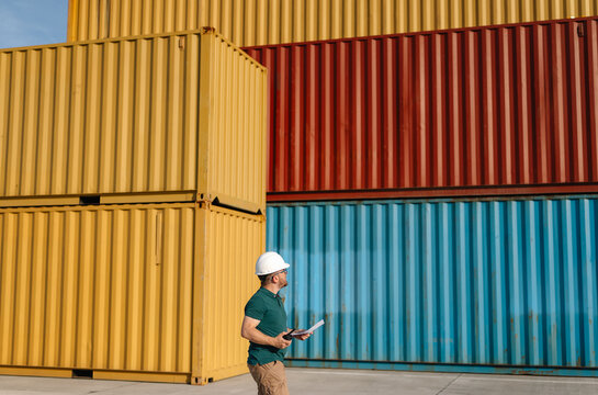 Logistics Supervisor Using Two-Way Radio at Container Shipping Yard