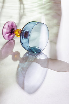 A colored glass with wine in it has fallen.
