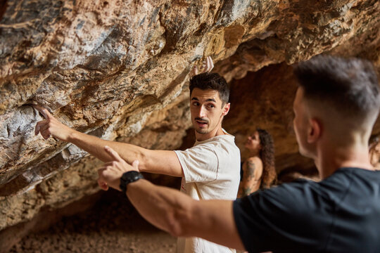 Climbers practice techniques in a cave during the daytime