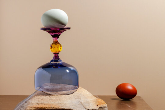 Egg on colored glass on a stone