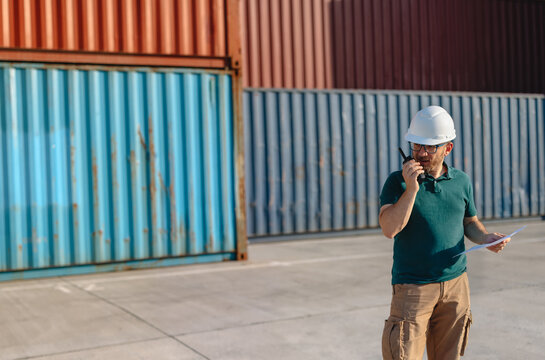 Logistics Supervisor Using Two-Way Radio at Container Shipping Yard
