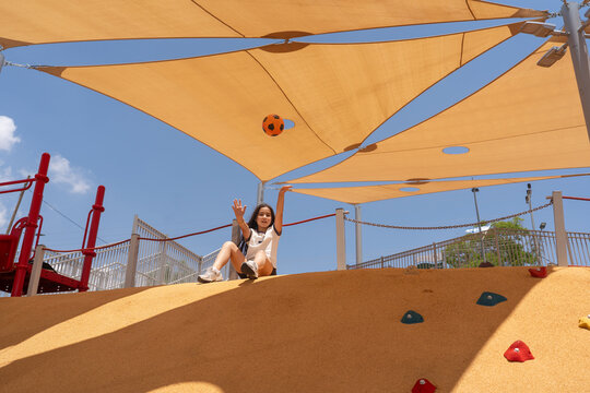 Girl Playing With Soccer Ball On Sunny Playground