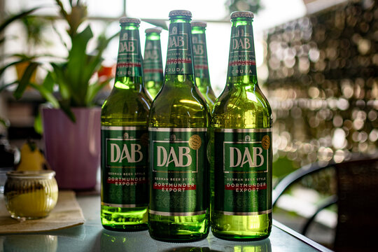 Athens,Greece-July 12 2026. Bottles of the DAB German beer on a glass table.