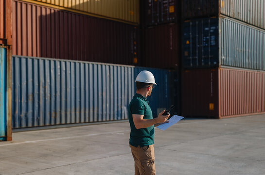 Logistics Supervisor Using Two-Way Radio at Container Shipping Yard