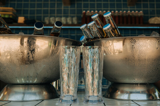 Chilled glass bottles cooling in metal ice buckets