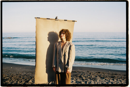Woman on beach with studio backdrop and shadow