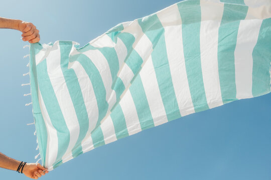 Striped Beach Towel In Wind Blue Sky