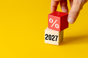 Financial forecasting and interest rates concept with hand placing red wooden block with percent...