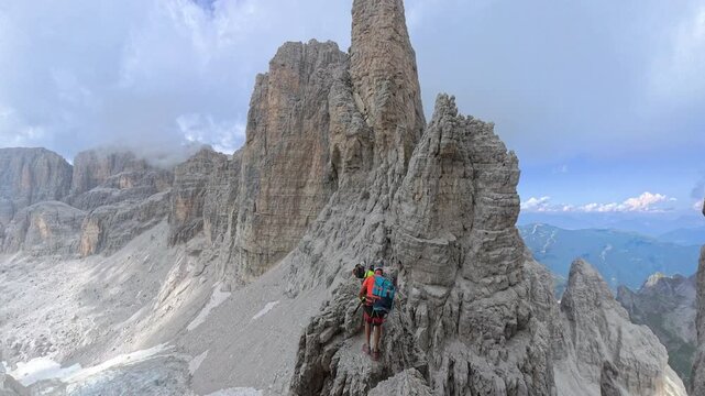 Group of hikers descending toward Bocca degli Armi on Via Ferrata Bocchette Centrali, Brenta Dolomites